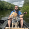 Arran Wilson and his dog in a canoe