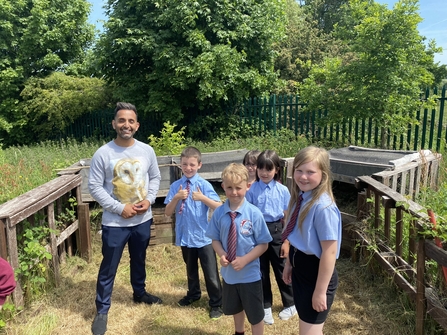 Pupils in outdoor learning area with Dr Amir Khan