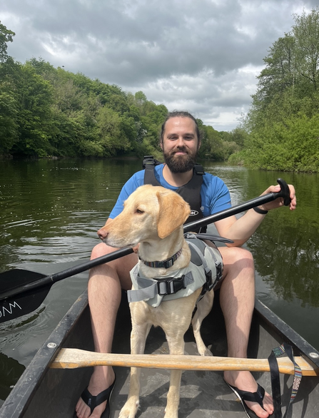 Arran Wilson and his dog in a canoe