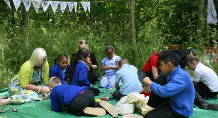 Forest School children making woodland crafts