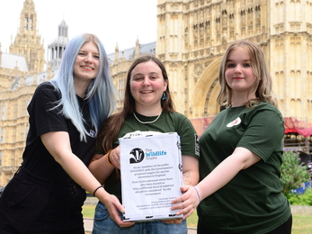 3 women holding petition