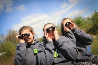 Young people looking through binoculars