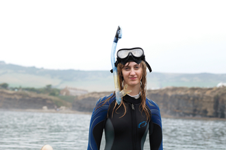 Heather in a wetsuit in the sea