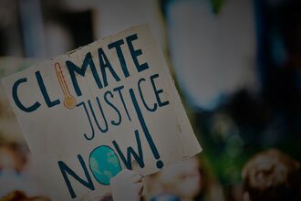 Sign reading climate justice now