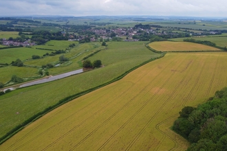 Aerial photo of the Court Farm site featuring fields and hedgerows