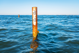 A marker in the middle of the sea is shown monitoring the sea water levels