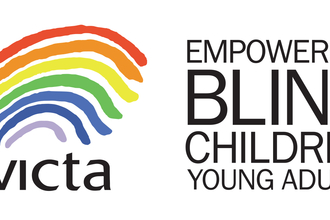 VICTA logo - A rainbow with the text VICTA - Empowering Blind Children + Young Adults