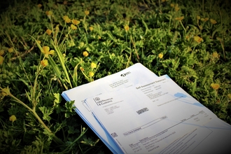 Bank documents lying on grass. 