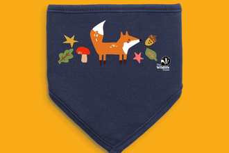 A dribble bib for a baby featuring illustrations of leaves, an acorn, fungi and a fox
