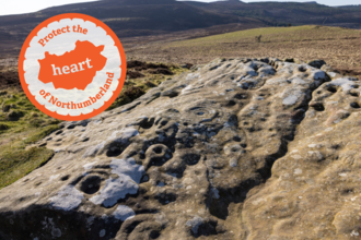 A large rock, flat to the ground but pitted with human carvings, the sweeping Rothbury estate in the background. An emblem in organge that says "Protect the heart of Northumberland"