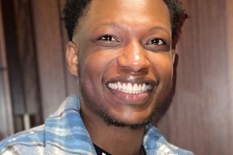Naftal Zinyemba smiling at the camera