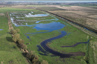 An aerial shot of a meandering flood plain