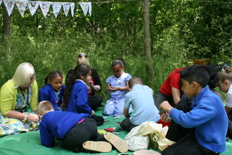 Forest School children making woodland crafts