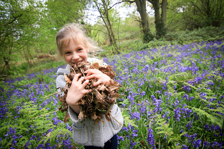 Child with leaves & bluebells (c) Tom Marshall