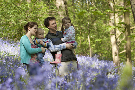 Family outdoors in bluebells