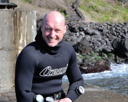 Man in a wetsuit smiling