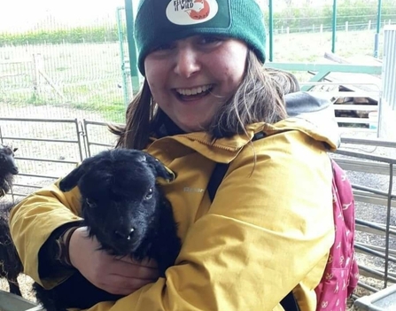 Mia holding a lamb