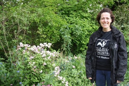 A Wildlife Officer in St Albans standing in front of shrubs