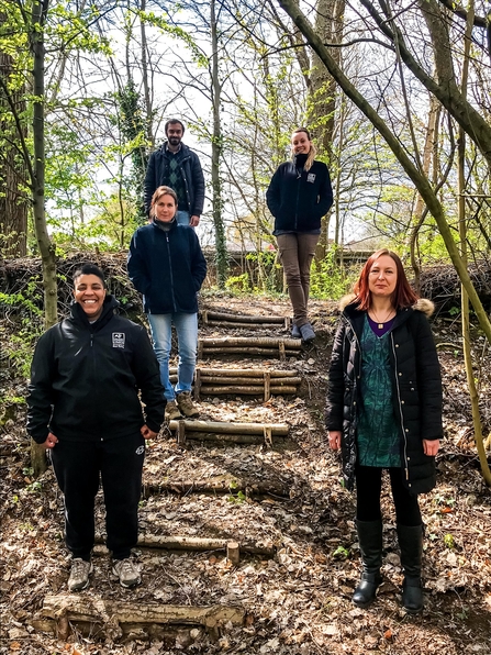 5 Natural Prospect trainees standing on woodland steps