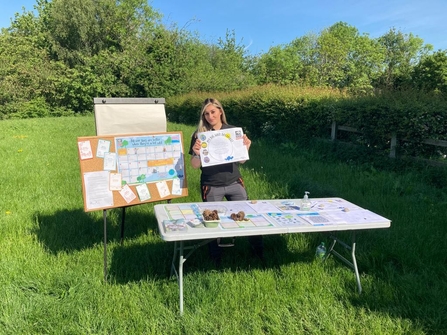 Aneesha Davies stood at a nature table holding a poster