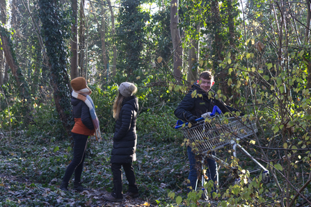3 supporters at Cheshire Wildlife Trust cleaning and removing a trolley