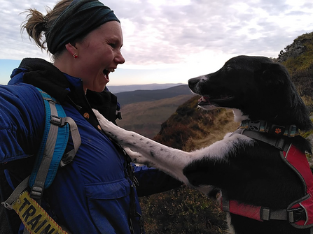 Sarah-Kay from The Wildlife Trust of South and West Wales smiles at Lily, her rescue collie, who has her front paws on Sarah-Kay's chest