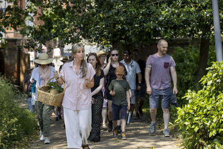 Group of people walking through a garden