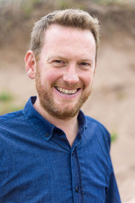 James Keetley stood outdoors, smiling at the camera