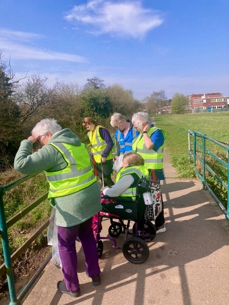 A group of people outside in high vis jackets