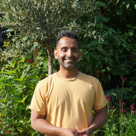 Dr Amir Khan smiling in the garden