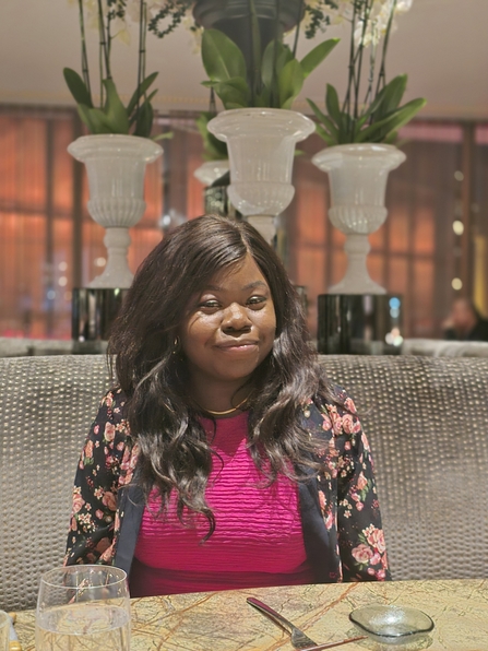 Nanret Senok sat at a table, smiling at the camera