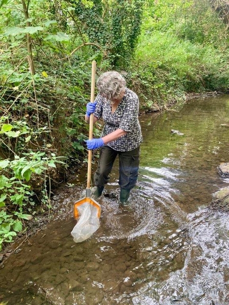 Woman in river with a net