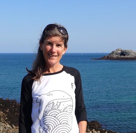 Ruth Williams similing by the sea