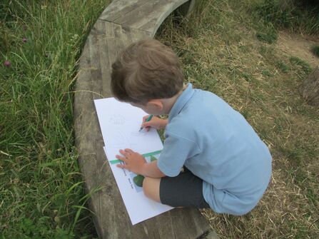 Child drawing outside