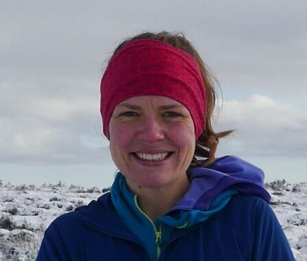 Elsie smiling out in nature with a snowy background