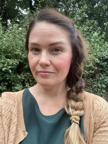 Rina Quinlan smiling outside in nature