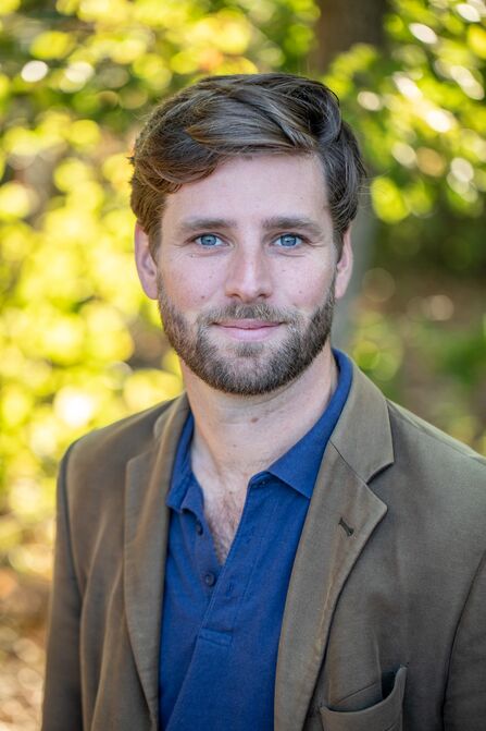 Stan Smith similing outside in nature