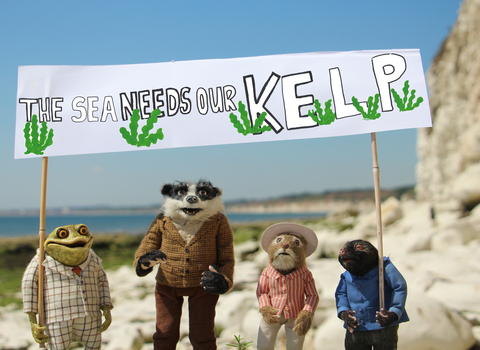 puppets holding sign