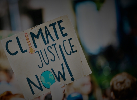 Sign reading climate justice now