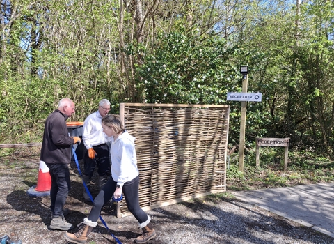 willow fence and three people