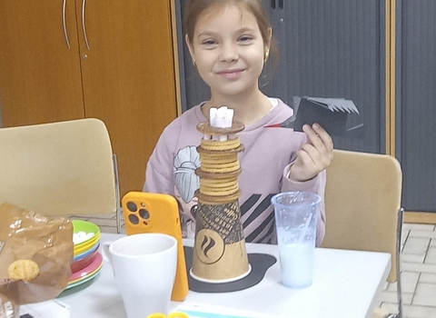 girl with sculpture of lighthouse